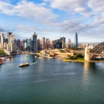 Waterfront architectural landmarks of Sydney city CDB around Circular quay and the Rocks on shores of Harbour in aerial cityscape.