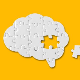 Brain shaped white jigsaw puzzle on yellow background, a missing piece of the brain puzzle, mental health and problems with memory