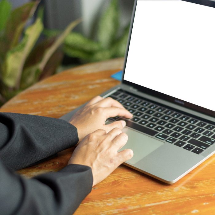 Close-up of hands writing on laptop