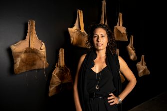 Artist Nicole Monks at barangga exhibition with her kangaroo skin bags