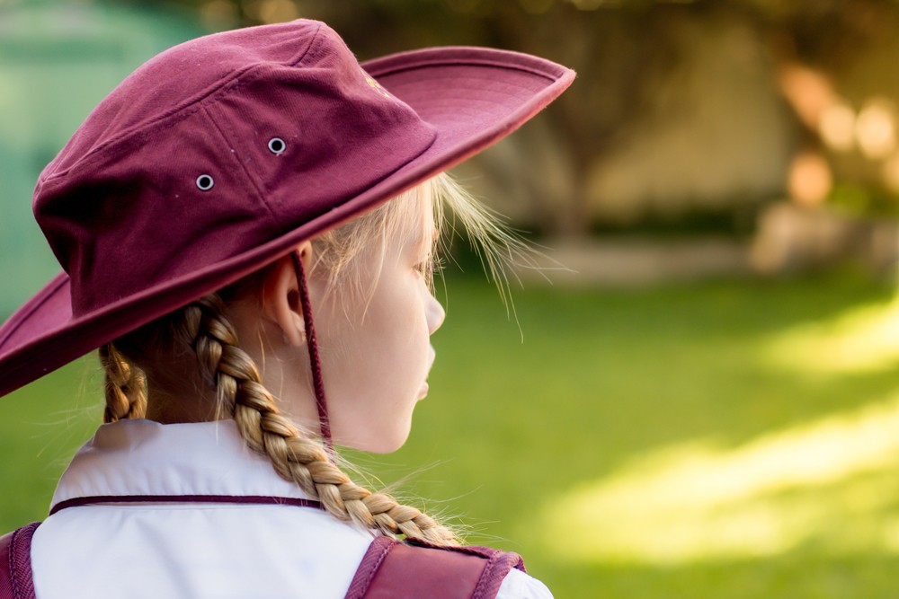 School girl wearing maroon uniform