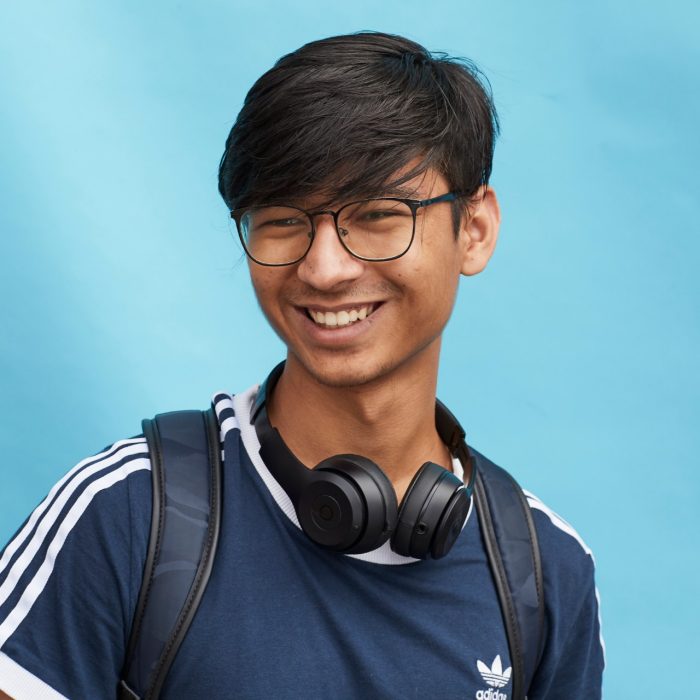 Happy student on coloured background