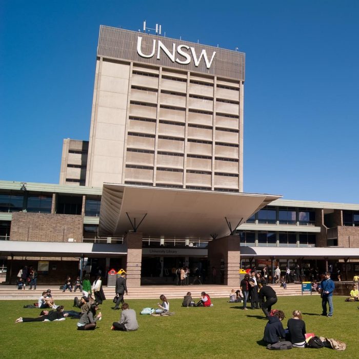 Sydney, Australia - August 17, 2012: Students and graduates converge on a lawn before the University of New South Wales (UNSW) library on a clear winter morning