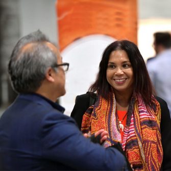 lady smiling at man at conference