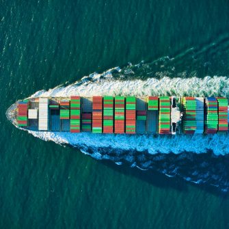 Aerial view of blue and white boat on body of water during daytime photo