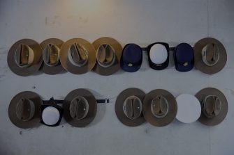 Collection of military hats hanging on a wall