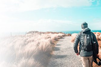 Hiker walking along track through countryside of Tasmania