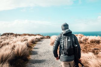 Hiker walking along track through countryside of Tasmania