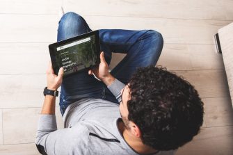 Photo of person from above browsing UNSW website on a tablet