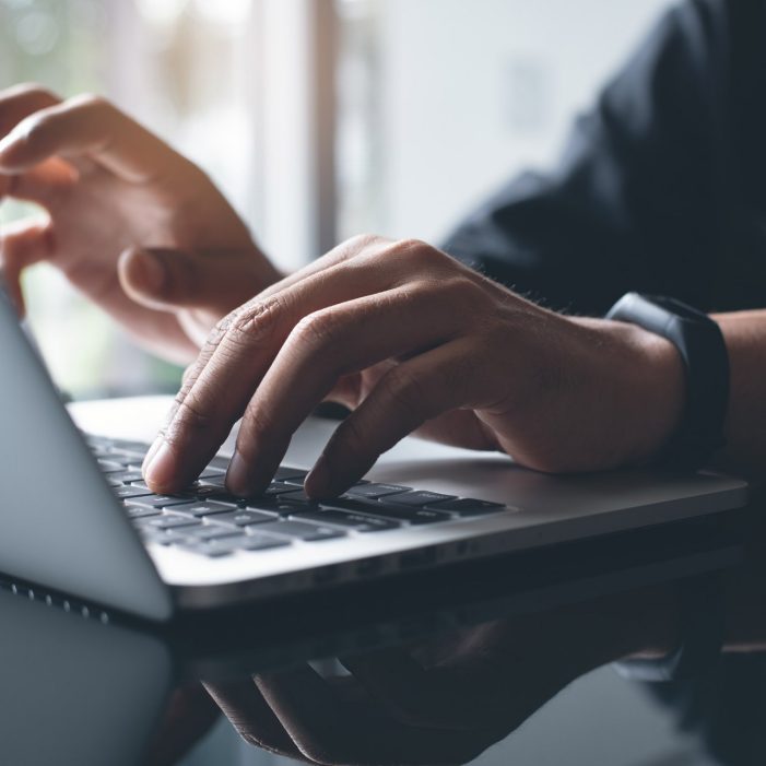 Photo of a person working on laptop computer