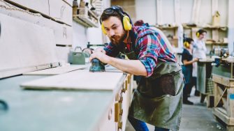 Photo of carpenter in safety headphones