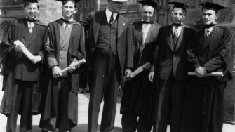 archive image of student graduates and professor