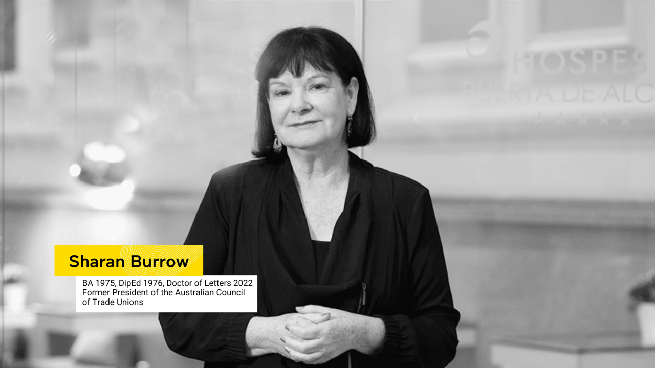 Sharan Burrow in black and white with hands clasped in front of her