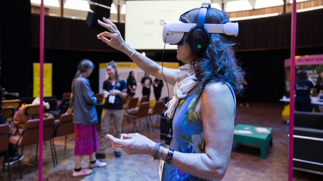 A guest at the Massive Action Sydney Unconvention engaging with the Big Trauma, Big Change project team's VR experience