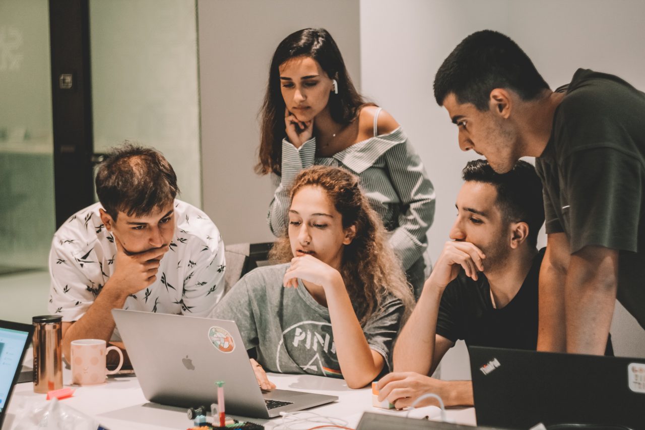 Group of students looking at laptop screen