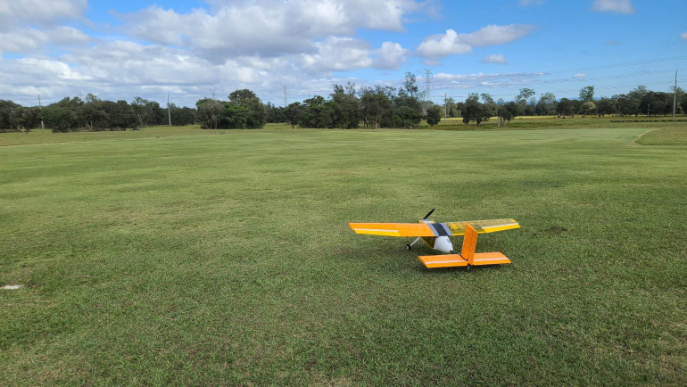 AIAA Design Build Fly image of a plane in an open field