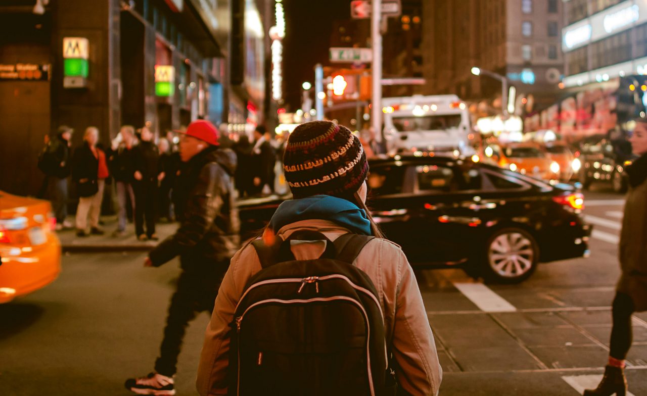 Person crossing highway during nighttime