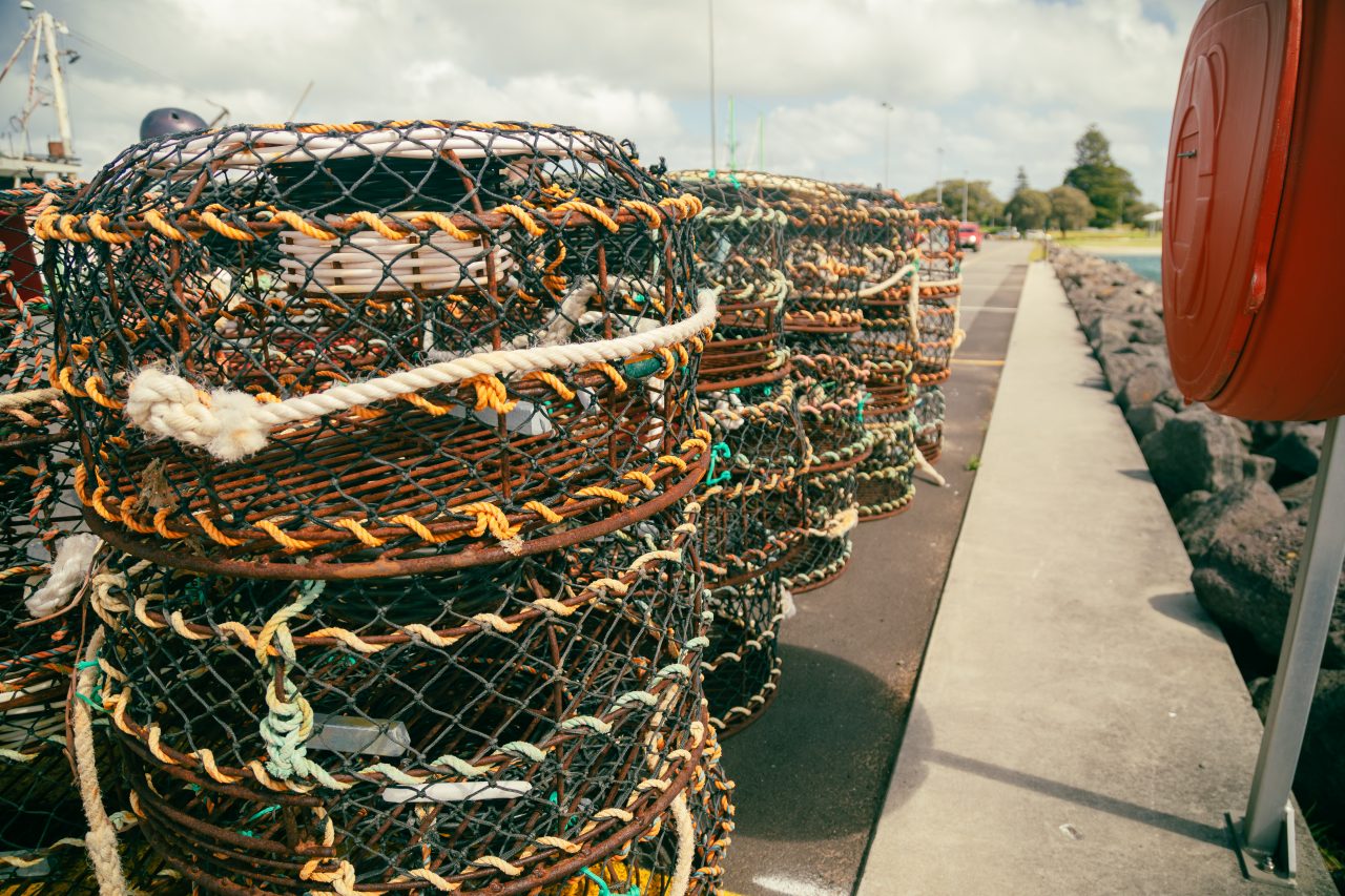 Cray pots lined stacked on jetty at the Port of Portland, Victoria Australia