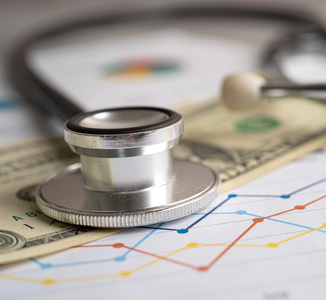 Stethoscope with US dollar banknote on graph paper, Finance, Account, Statistics, Investment, Analytic research data economy and business company.