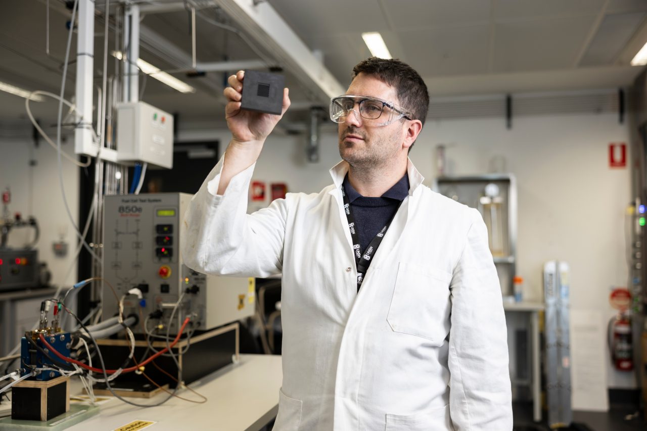 Dr Quentin Meyer in the UNSW hydrogen fuel cell laboratory, with a fuel cell tester in the background