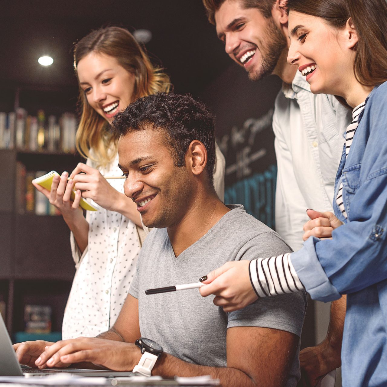 Stock photo of students doing group project in campus library