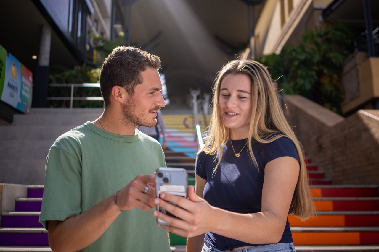 Two students checking directions by the Basser Steps